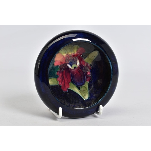 575 - A MOORCROFT POTTERY CIRCULAR TRINKET BOWL, dark blue ground with orchid design, impressed marks, app... 