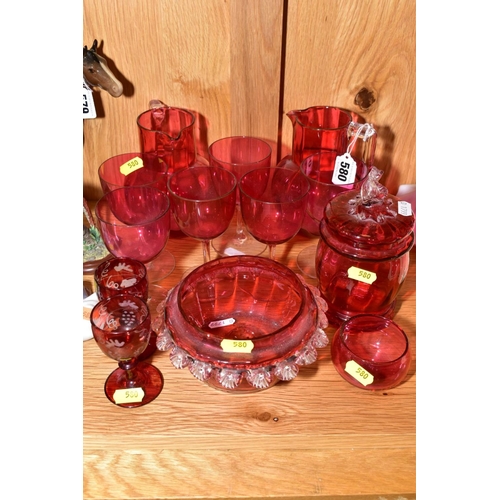 580 - THIRTEEN PIECES OF CRANBERRY GLASS, comprising two jugs, approximate height 14cm, a set of six glass... 