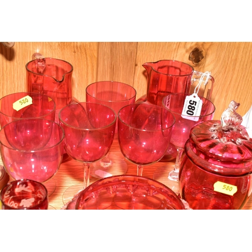 580 - THIRTEEN PIECES OF CRANBERRY GLASS, comprising two jugs, approximate height 14cm, a set of six glass... 