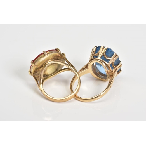 63 - TWO LARGE GEMSTONE RINGS, the first designed with a large oval cut carnelian panel within an eight c... 