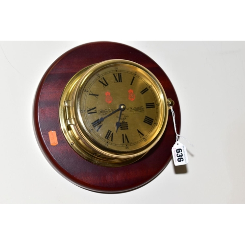 636 - AN S.E.WILLS REPLICA SHIPS CLOCK, metal cased fixed to a wooden surround, battery operated, approxim... 