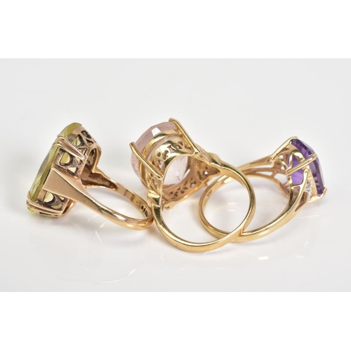 64 - THREE 9CT GOLD GEM SET RINGS, the first an oval cut citrine within a double four claw setting and lo... 