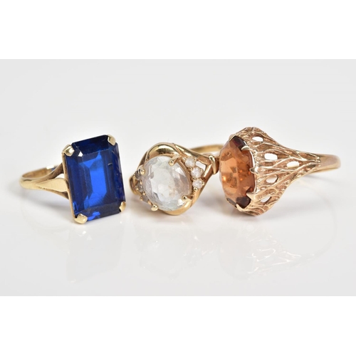 65 - THREE 9CT GOLD GEM SET RINGS, to include an oval cut topaz within a four claw setting to the circula... 