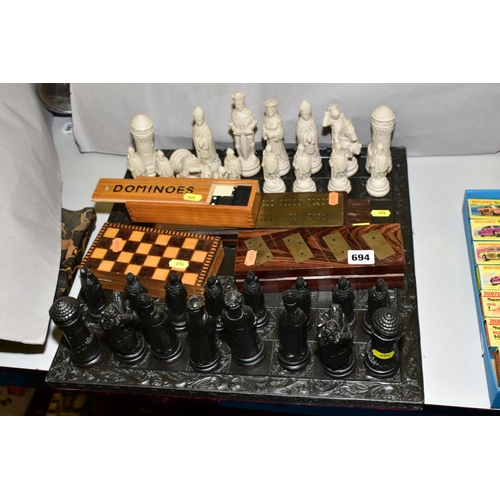 694 - A MODERN RESIN CHESS SET, with medieval style chess men, together with cribbage boards, dominoes and... 