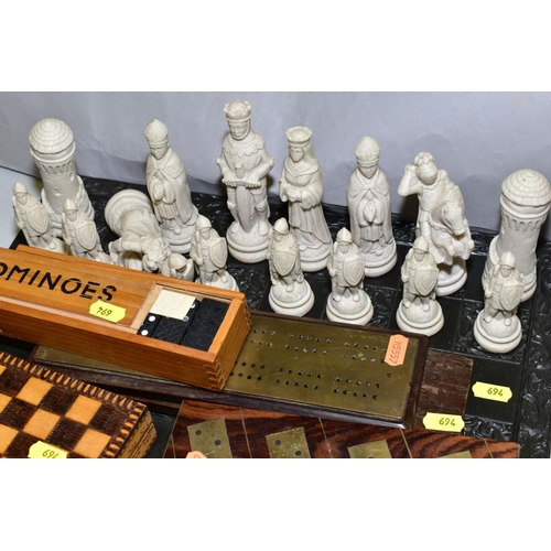 694 - A MODERN RESIN CHESS SET, with medieval style chess men, together with cribbage boards, dominoes and... 