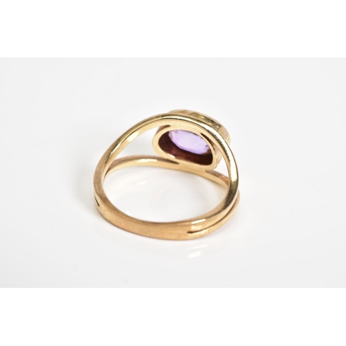 79 - AN AMETHYST SET RING, yellow metal ring set with an oval cut amethyst within a collect mount to the ... 