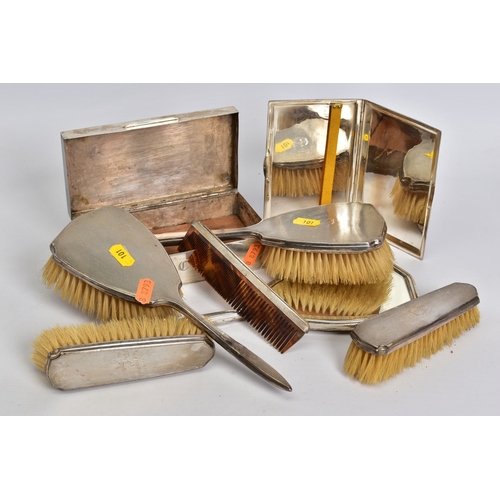 101 - A GROUP OF SILVER AND WHITE METAL, comprising a six piece silver mounted dressing table set, engine ... 