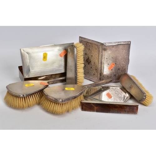 101 - A GROUP OF SILVER AND WHITE METAL, comprising a six piece silver mounted dressing table set, engine ... 