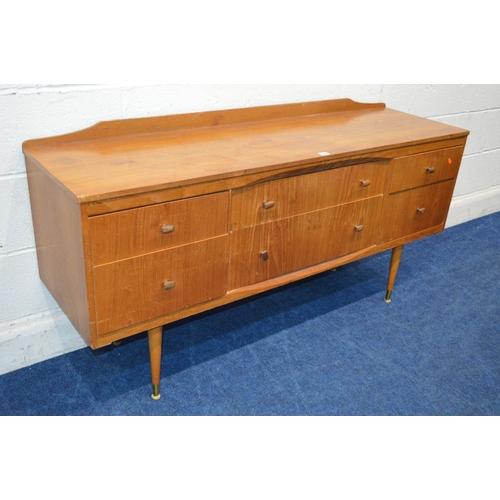 1337 - A MID 20TH CENTURY TEAK SIDEBOARD, with six assorted drawers, on four cylindrical tapering legs, wid... 