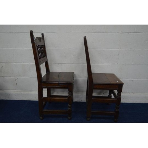 1339 - A NEAR PAIR OF EARLY 19TH CENTURY HEAVY OAK HALL CHAIRS, carved and spindled back, on turned and blo... 