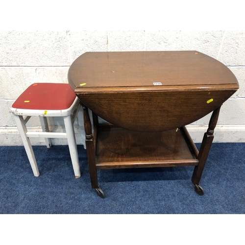 1230 - AN OAK OVAL TOP DROP LEAF TEA TROLLEY, together with a walnut circular occasional table, oak open bo... 