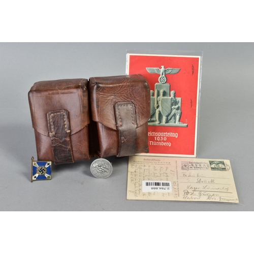 141 - A NUMBER OF WWII GERMAN ITEMS AS FOLLOWS:- two x Reichspateitag Propoganda postcards Nurnberg 1935, ... 