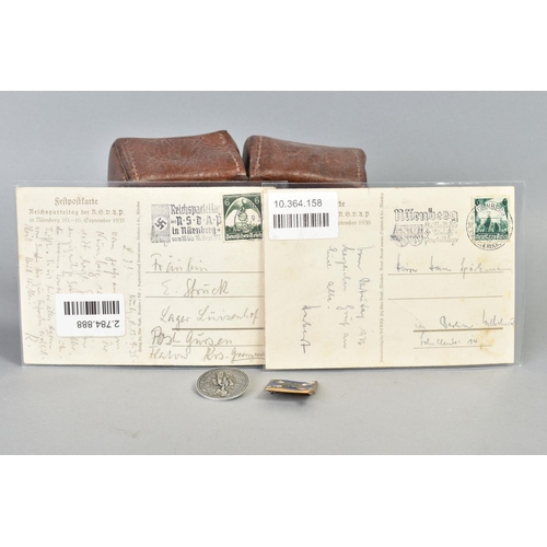 141 - A NUMBER OF WWII GERMAN ITEMS AS FOLLOWS:- two x Reichspateitag Propoganda postcards Nurnberg 1935, ... 