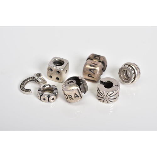 25 - A COLLECTION OF SIX PANDORA CHARMS, to include a dice, letter C initial set with colourless paste, t... 