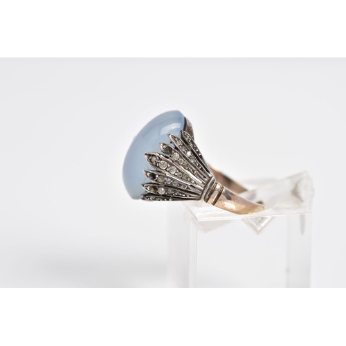 3 - A MOONSTONE CABOCHON RING, the yellow metal ring designed with an oval cut cabochon moonstone, withi... 