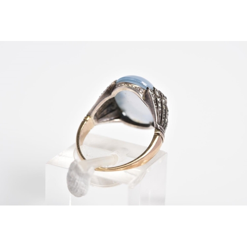 3 - A MOONSTONE CABOCHON RING, the yellow metal ring designed with an oval cut cabochon moonstone, withi... 