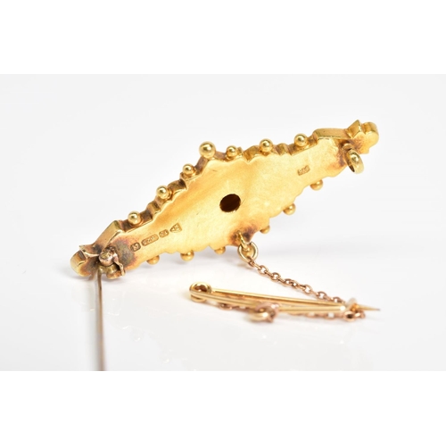 37 - AN EARLY 20TH CENTURY 15CT GOLD BROOCH, the embossed floral panel with a raised circular centre feat... 