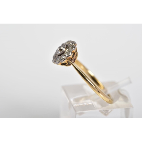 55 - A DIAMOND CLUSTER RING, the yellow metal ring set with a central old cut diamond and a single cut di... 