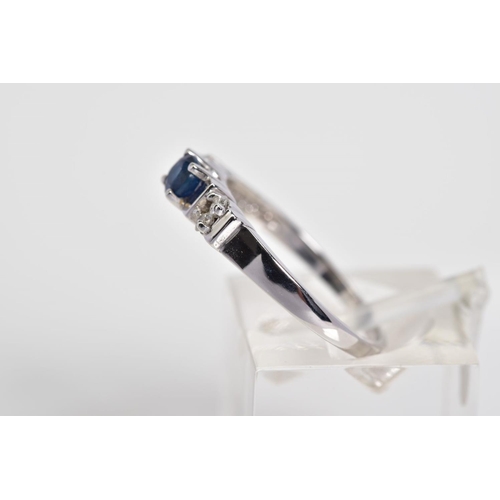 60 - A 9CT WHITE GOLD SAPPHIRE AND DIAMOND RING, designed with a central claw set circular cut sapphire, ... 