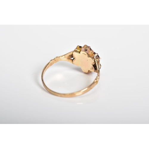 8 - A GARNET SET CLUSTER RING, the yellow metal ring designed as a cluster set with seven circular cut g... 