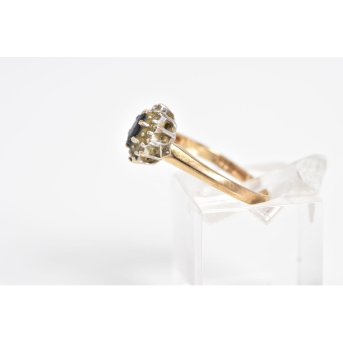9 - A 9CT GOLD SAPPHIRE AND DIAMOND CLUSTER RING, set with a central oval cut sapphire within a single c... 
