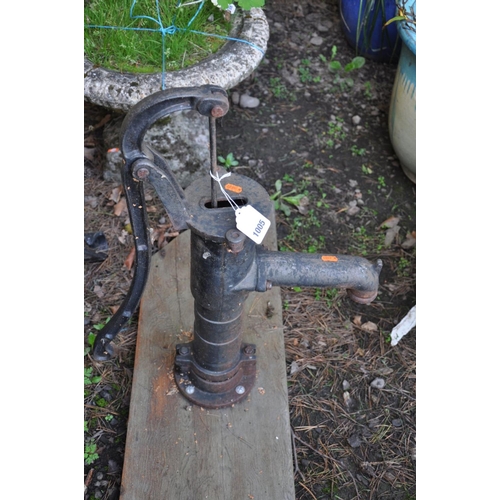 1005 - A VINTAGE CAST IRON WATER PUMP mounted on a wooden plank, height 67cm and a vintage wrought flat iro... 