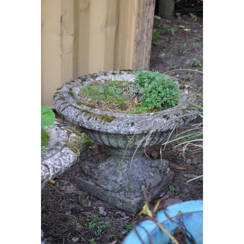 1006 - A PAIR OF COMPOSITE GARDEN URNS with fluted detail to bowl standing on a square base, diameter 54cm ... 