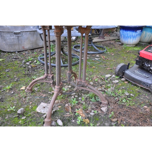 1015 - A MODERN GARDEN TABLE with a cast iron base in the form of four shaped Victorian style legs bolted t... 