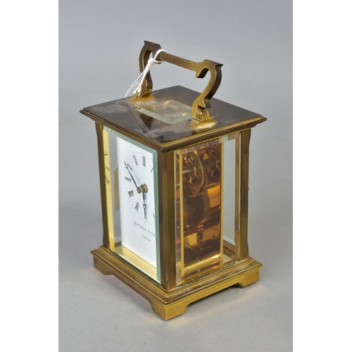 102 - A MATTHEW NORMAN OF LONDON BRASS CASED CARRIAGE CLOCK, white enamel dial with Roman numerals, back p... 