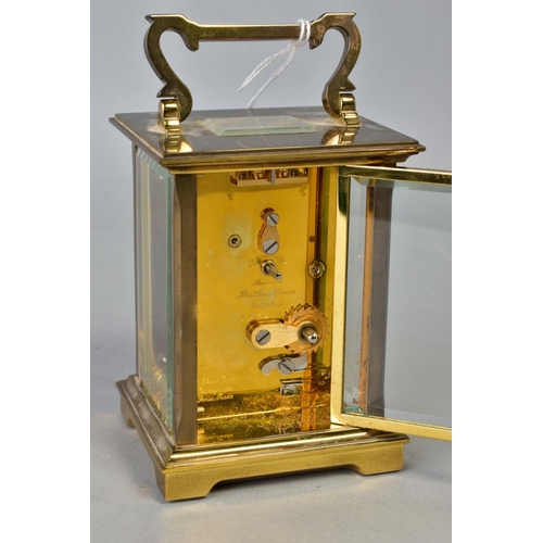 102 - A MATTHEW NORMAN OF LONDON BRASS CASED CARRIAGE CLOCK, white enamel dial with Roman numerals, back p... 