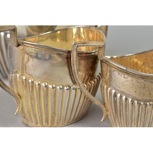 104 - A LATE VICTORIAN SILVER THREE PIECE BACHELORS TEA SET, of oval form, stop reeded decoration, makers ... 