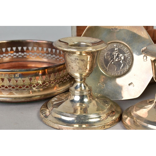 111 - A PARCEL OF SILVER, including a pair of dwarf candlesticks, circular loaded bases, one damaged to st... 