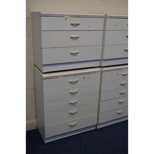 1202 - A MODERN WHITE BEDROOM SUITE, comprising four chest of drawers, dressing table with rectangular mirr... 