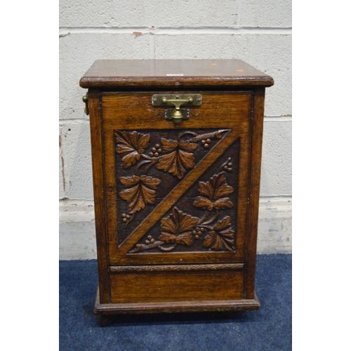 1207 - A LATE 19TH/EARLY 20TH CENTURY CARVED OAK PURDONIUM with a fall front door, width 37cm x depth 33cm ... 