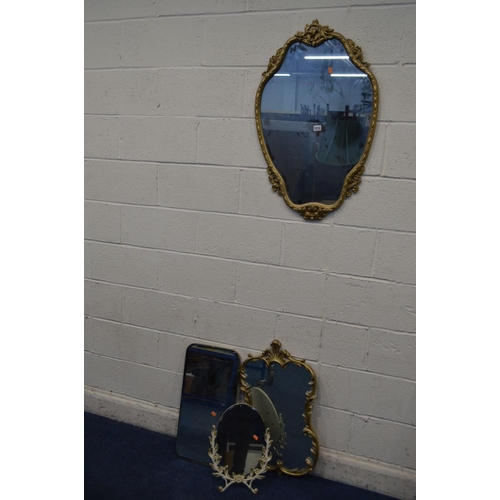 1212 - A LATE 20TH CENTURY FOLIATE GILT METAL SHAPED WALL MIRROR, 54cm x 86cm together with a similar gilt ... 