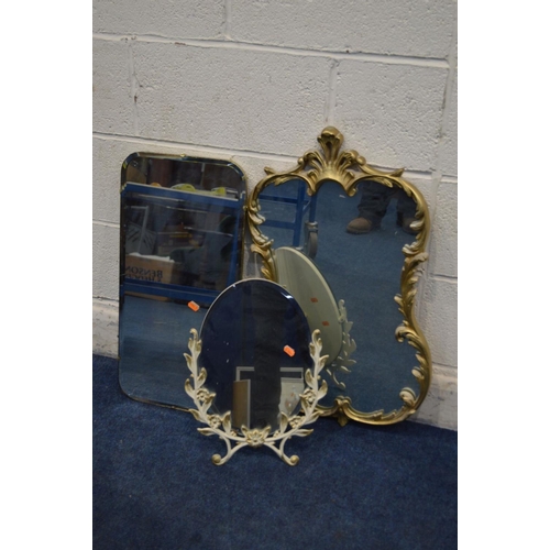 1212 - A LATE 20TH CENTURY FOLIATE GILT METAL SHAPED WALL MIRROR, 54cm x 86cm together with a similar gilt ... 