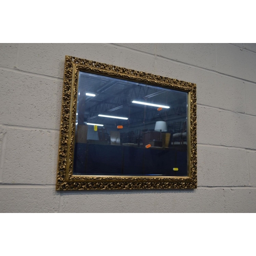 1213 - A MODERN GILT WOOD BEVELLED EDGE WALL MIRROR, 71cm x 101cm together with a heavily gilt framed bevel... 