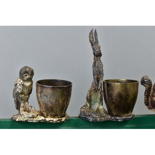 124 - A GROUP OF SILVER PLATED EGG CUPS, NAPKIN RINGS AND NUT DISHES, each with a cast bird or animal, inc... 