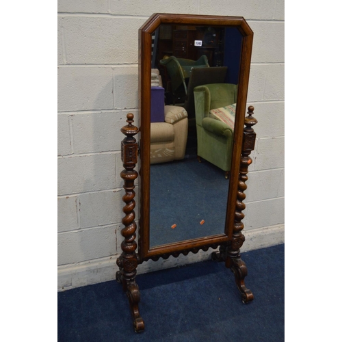 1242 - A LATE VICTORIAN WALNUT CHEVAL MIRROR, with canted top corners, supported on twin supports with turn... 