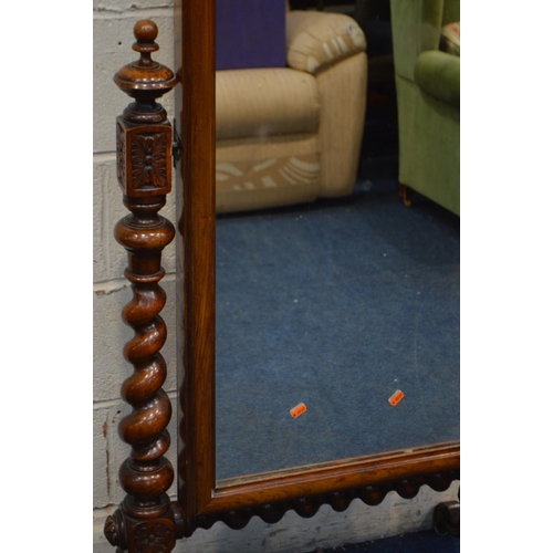 1242 - A LATE VICTORIAN WALNUT CHEVAL MIRROR, with canted top corners, supported on twin supports with turn... 