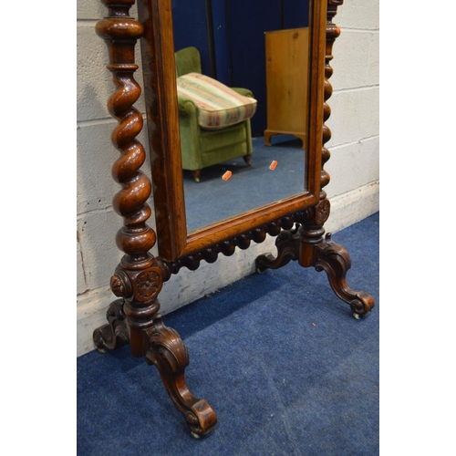 1242 - A LATE VICTORIAN WALNUT CHEVAL MIRROR, with canted top corners, supported on twin supports with turn... 