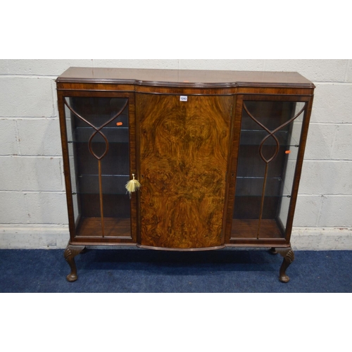 1243 - AN EARLY MID 20TH CENTURY BURR WALNUT THREE DOOR CHINA CABINET, glass shelves, with a central bow fr... 