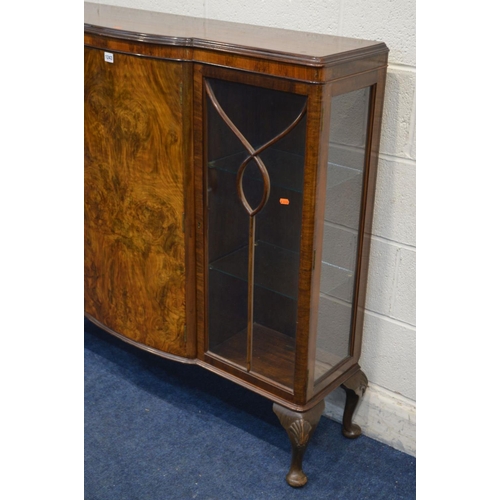 1243 - AN EARLY MID 20TH CENTURY BURR WALNUT THREE DOOR CHINA CABINET, glass shelves, with a central bow fr... 