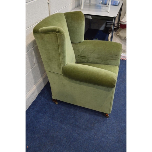 1246 - AN EARLY 20TH CENTURY GREEN UPHOLSTERED WINGED ARMCHAIR, with mahogany tapered legs terminated with ... 