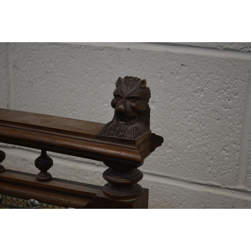 1248 - A LARGE EARLY 20TH CENTURY OAK FIRE SCREEN, with lion head's to top rail, turned and fluted upright'... 