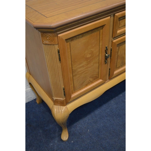 1253 - A MODERN LIGHT WOOD SIDEBOARD with decorative veneers to door and drawer panels, brass adornments on... 