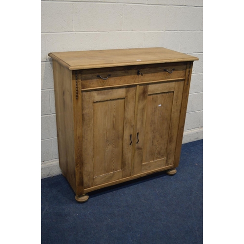 1267 - A 20TH CENTURY PINE PANELLED TWO DOOR CABINET with a single drawer, width 110cm x depth 52cm x heigh... 