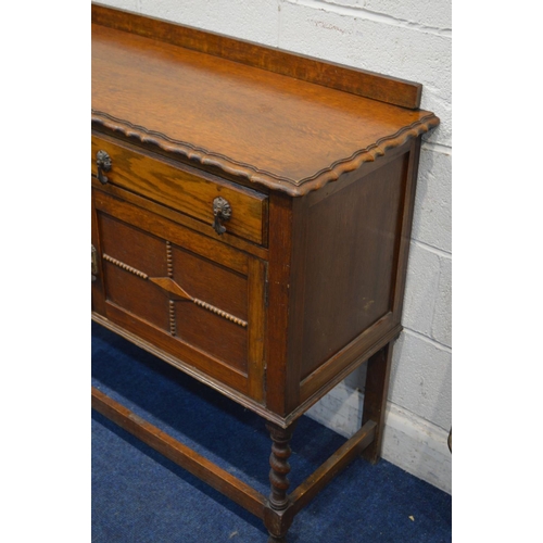 1268 - AN EARLY 20TH CENTURY OAK BARLEY TWIST SIDEBOARD, with a riased back and pie crust edging above two ... 