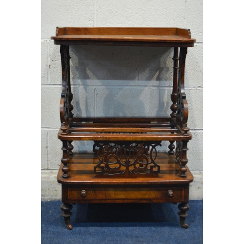 1295 - A VICTORIAN BURR WALNUT CANTERBURY, having a gallery top, on a pair of foliate scrolling and turned ... 