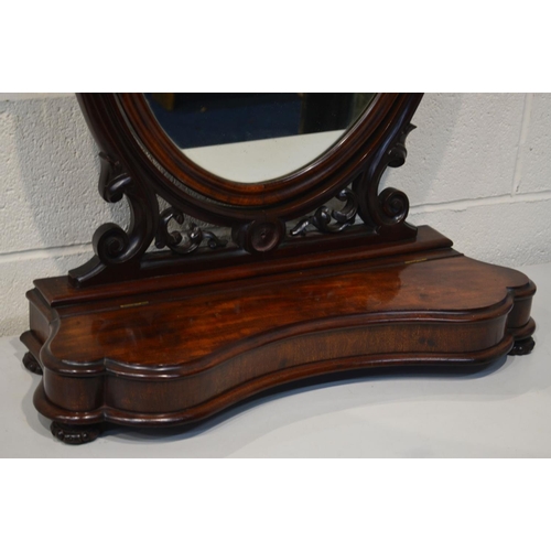 1297 - A VICTORIAN MAHOGANY OVAL TOILET MIRROR, with a serpentine base, width 71cm x height 84cm